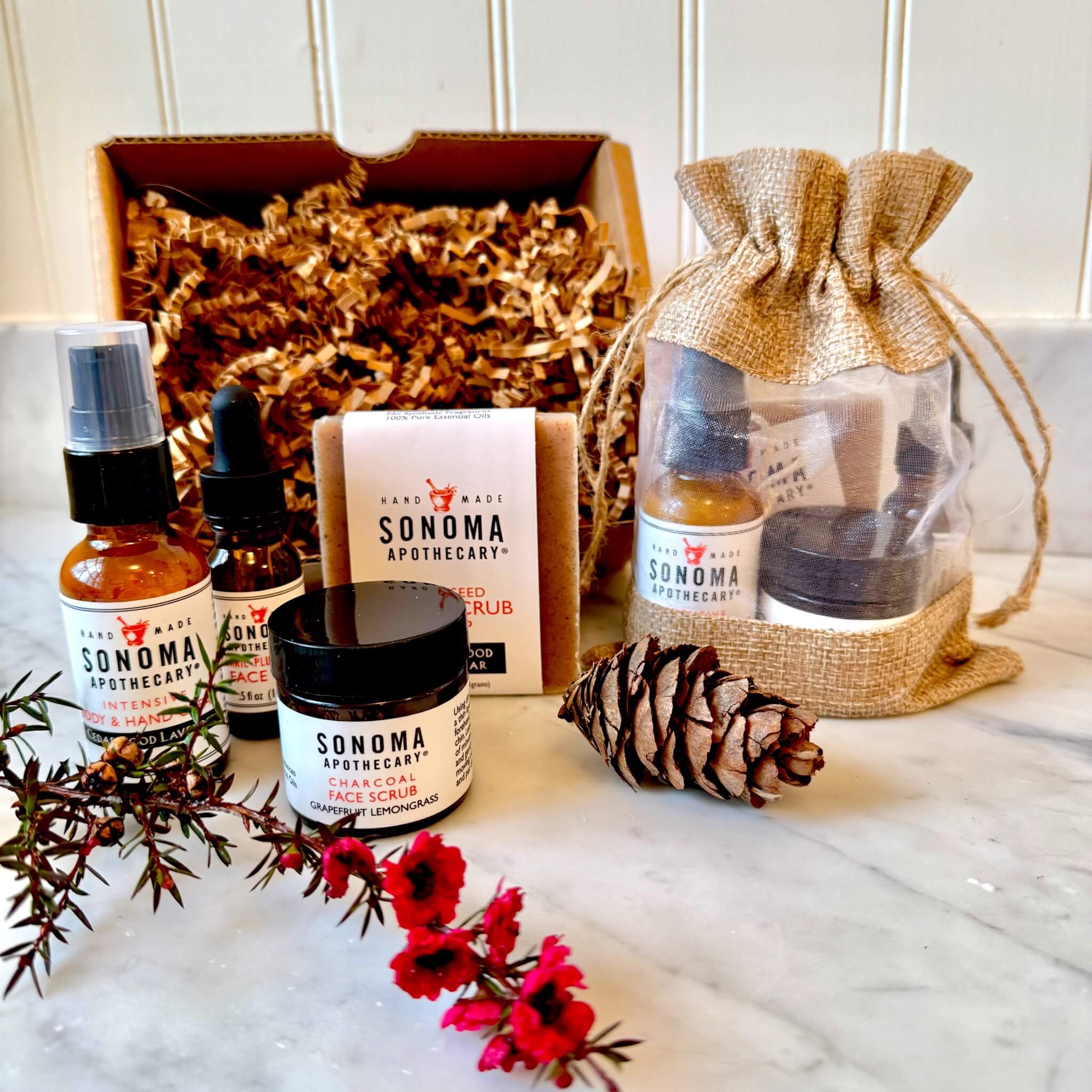 The Mini Ritual gift set with four travel-sized skincare essentials — Grapefruit Lemongrass cream, face scrub, mini soap, and face oil — displayed with decorative packaging.